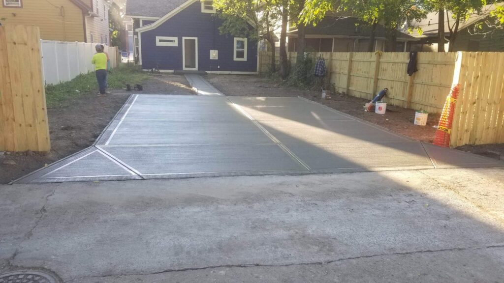 The driveway flares slightly at the road